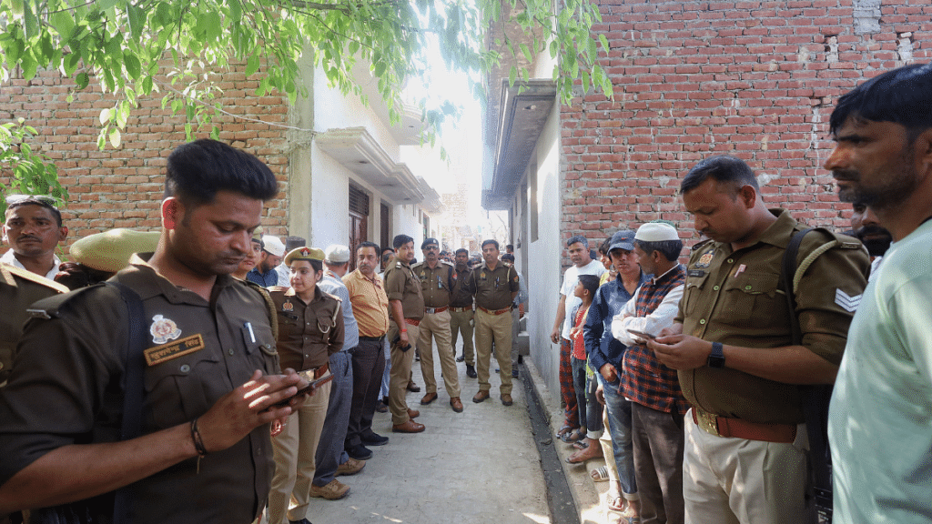 Police and local residents outside the house of Sajid, the main accused, in Budaun | Manisha Mondal | ThePrint