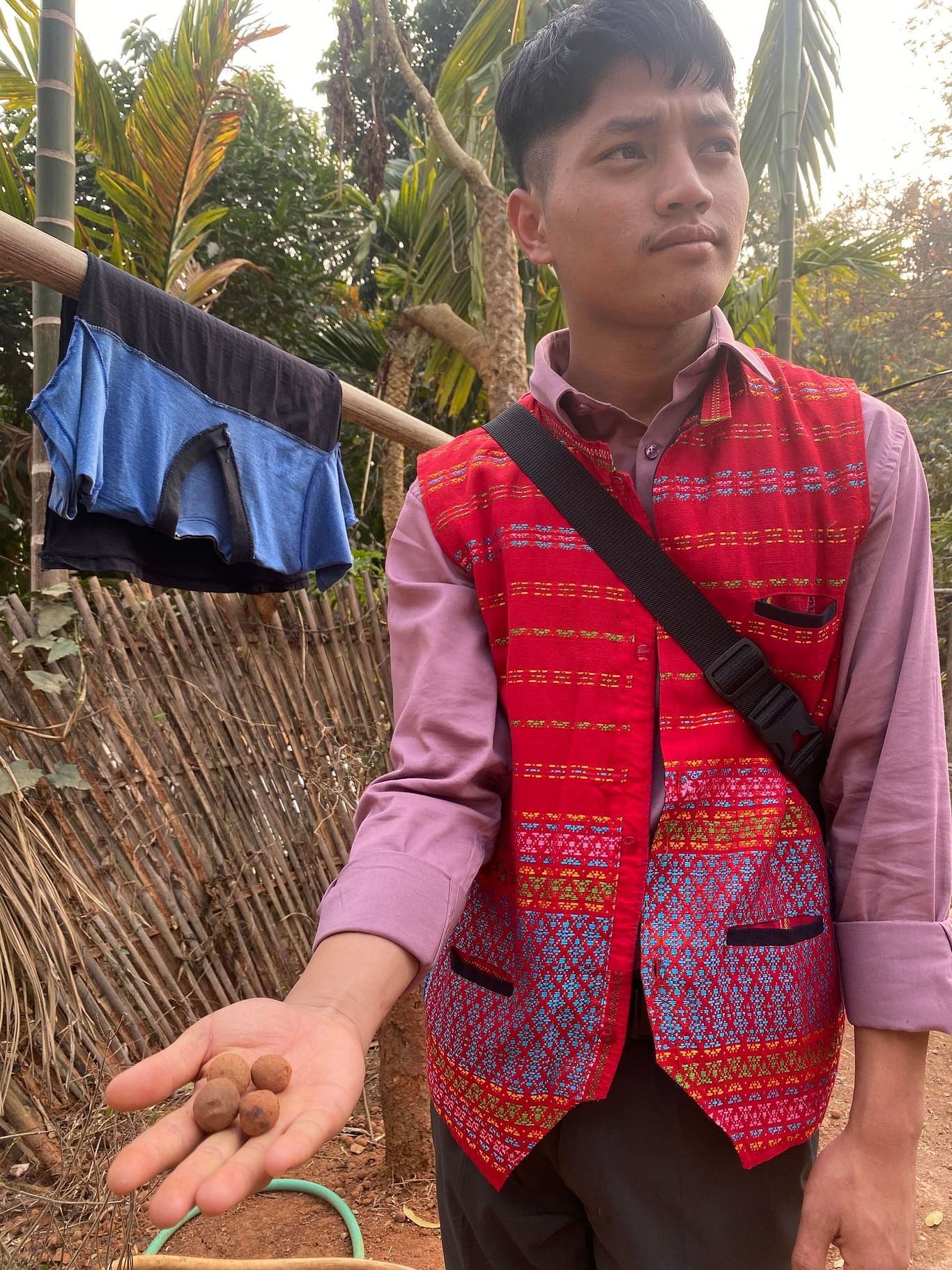 Green commando Krishna Chakma holds the seed bombs in his hand | Gitanjali Das | ThePrint