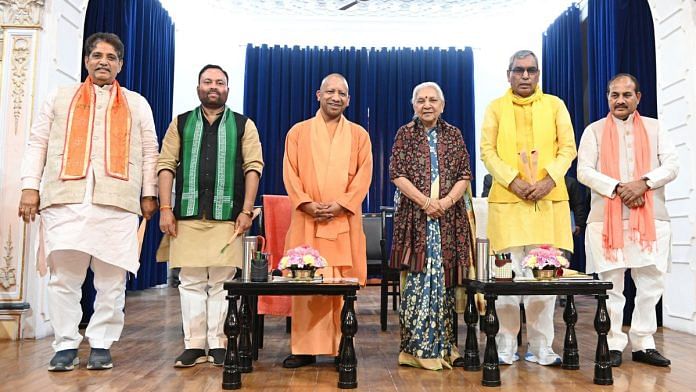 Uttar Pradesh Governor Anandiben Patel and Chief Minister Yogi Adityanath pose for a picture with newly sworn-in state cabinet ministers at the Governor's House, Lucknow, 5 February. | ANI