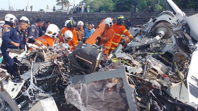 Emergency personnel work at the site of a helicopter crash in Lumut, Perak, Malaysia, April 23, 2024. Fire and Rescue Department of Malaysia (FRDM)/Handout via REUTERS