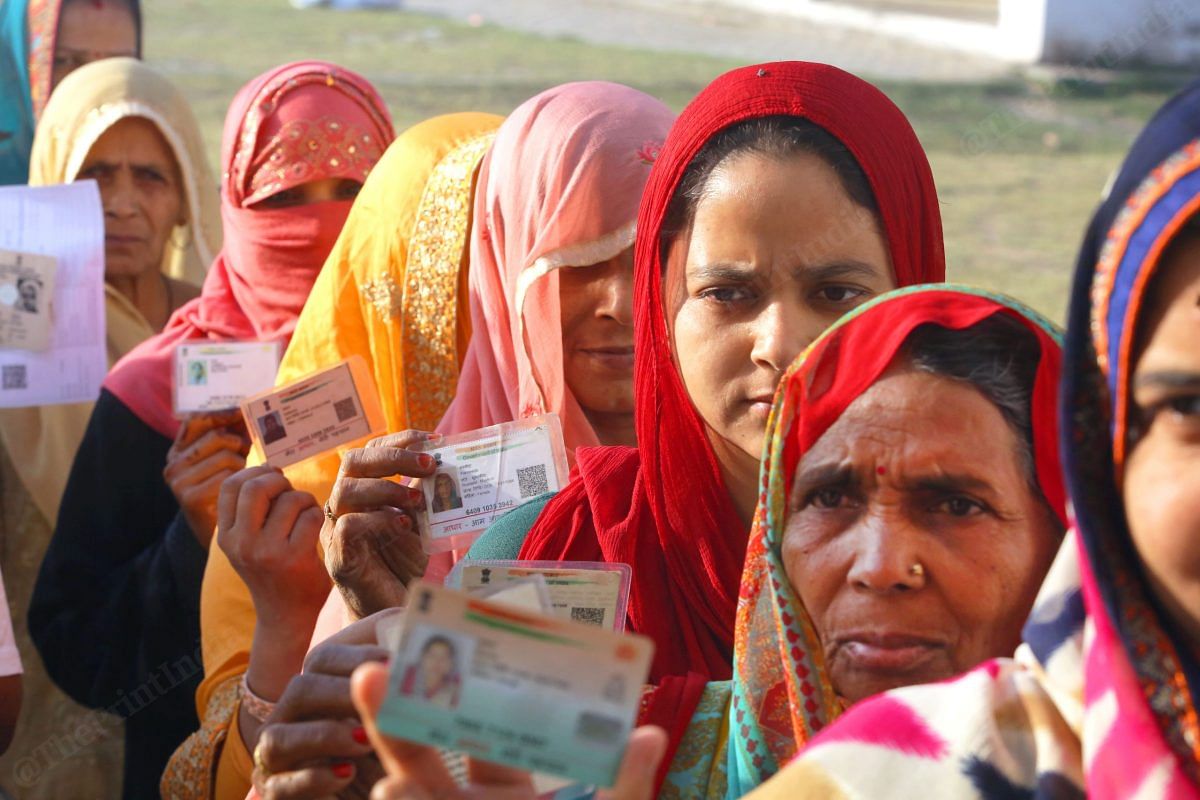 Women show their voter identity cards | Praveen Jain | ThePrint