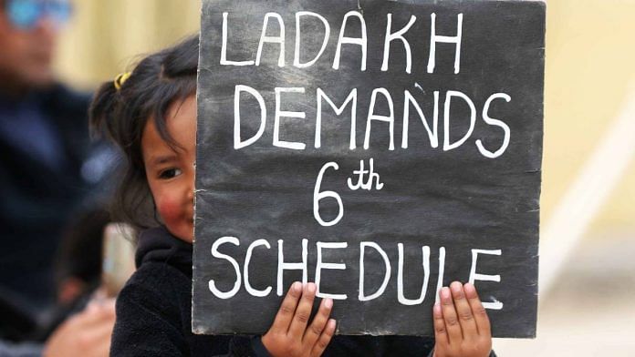 A child holds a placard at protest site in Leh | Manisha Mondal | ThePrint