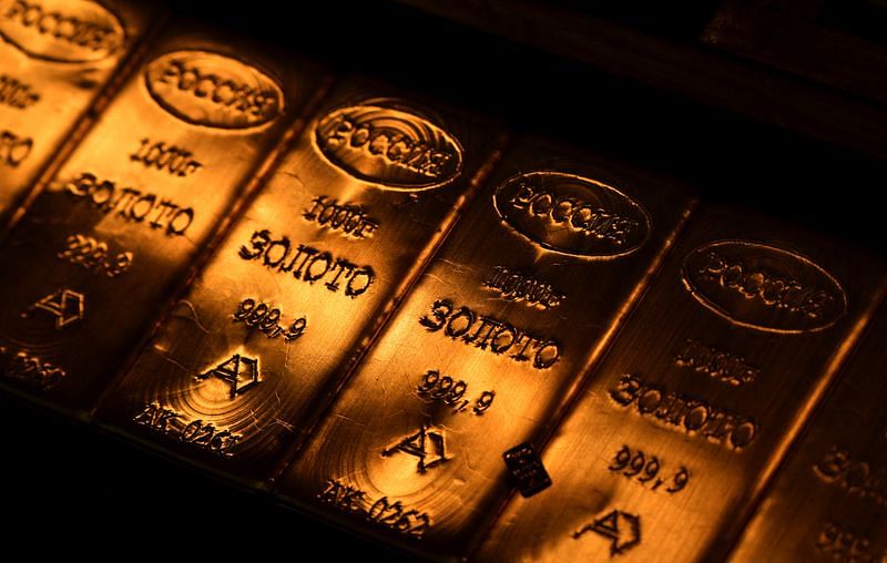 Gold slips as Fed meeting looms, but set for third monthly gain