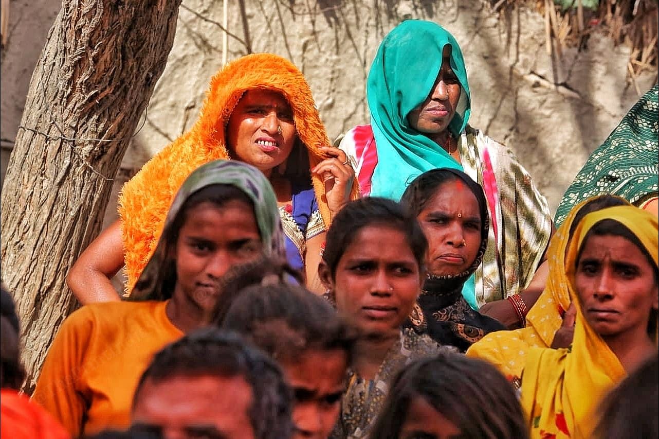 Women in ghoongats stand outside their homes to get a glimpse of their leader | Photo: Praveen Jain | ThePrint