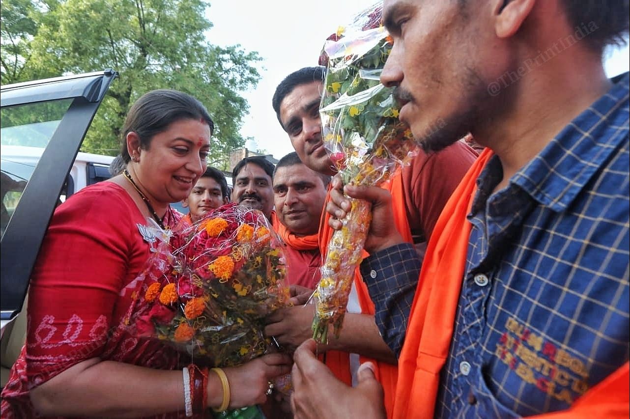Irani received flowers from the crowd in Mau Bazar | Photo: Praveen Jain | ThePrint