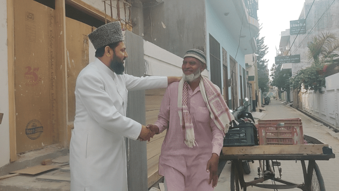 Maulana Mohibullah Nadvi engages an elderly fruit vendor in conversation in Rampur. Voting in Rampur is scheduled for 19 April 19 | Heena Fatima | ThePrint
