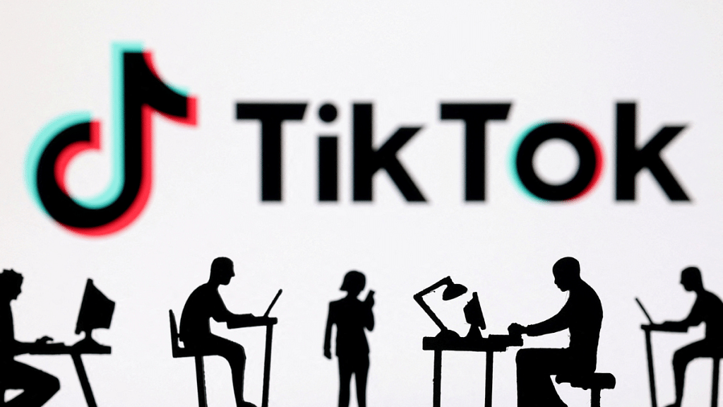Figurines with computers and smartphones are seen in front of TikTok logo in this illustration taken on 19 February, 2024 | Reuters