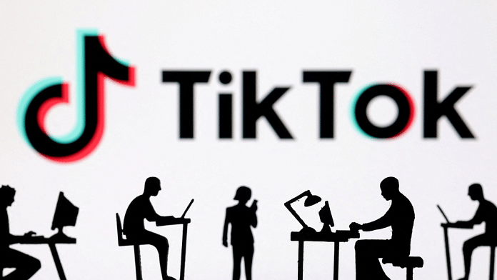 Figurines with computers and smartphones are seen in front of TikTok logo in this illustration taken on 19 February, 2024 | Reuters
