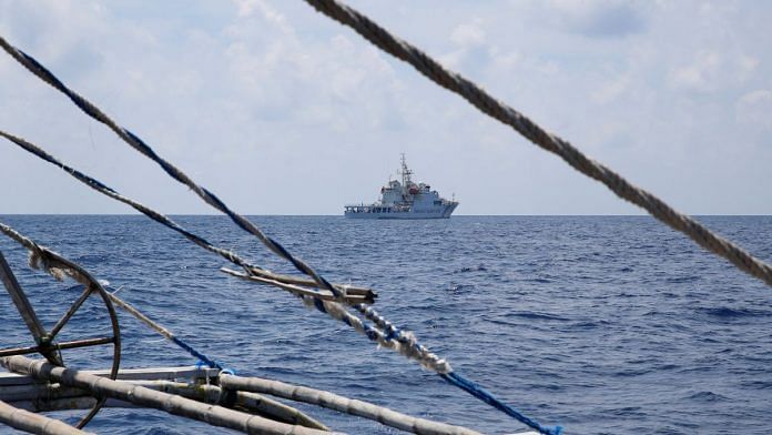 A China Coast Guard ship is seen from a Philippine fishing boat at the disputed Scarborough Shoal | REUTERS | Erik De Castro | File Photo