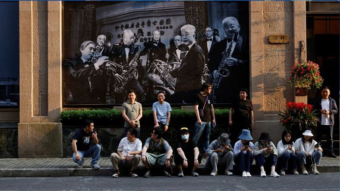 People rest on a street in Shanghai | File Photo | Reuters/Aly Song