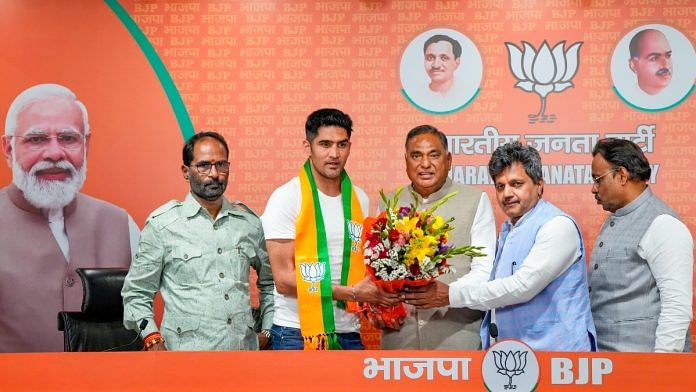 Boxer and former Congress leader Vijender Singh being greeted by BJP leader Ramvir Singh Bidhuri as he joins the party ahead of Lok Sabha elections, at BJP HQ in New Delhi, Wednesday, April 3, 2024 | PTI