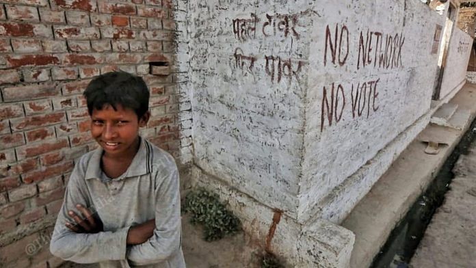 The slogan 'No Network, No Vote' is painted on the walls of Bharthapur village in Bahraich district, Uttar Pradesh | Photo: Praveen Jain | ThePrint