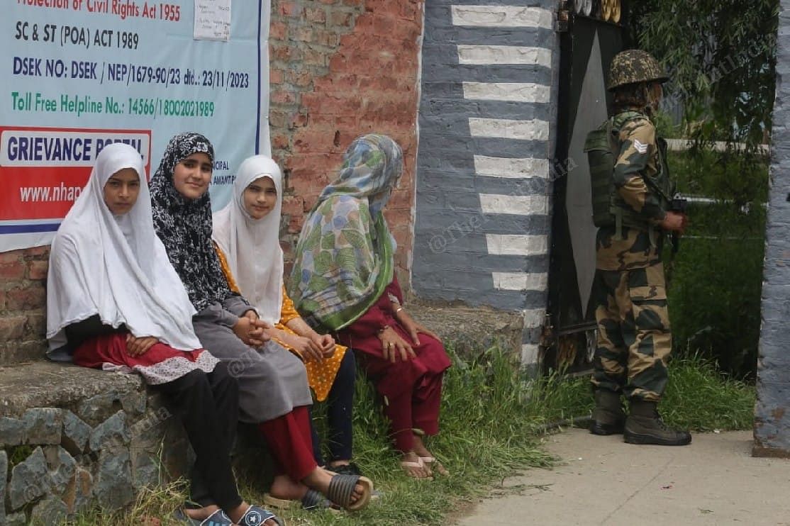 Girls waiting for their parents outside a polling booth in Tral, village of deceased Hizbul Mujahideen commander Burhan Wani | Praveen Jain | ThePrint