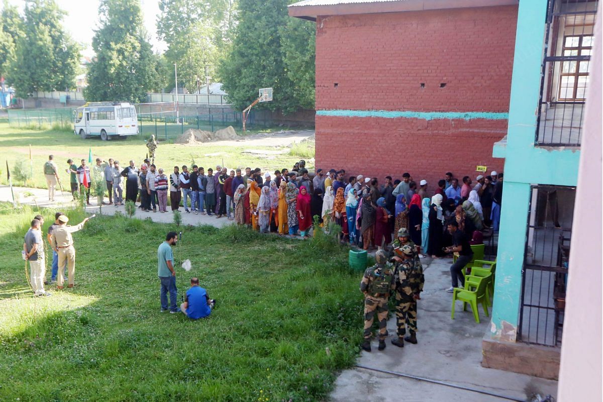 Voters queue to cast their votes at a polling station | Praveen Jain | ThePrint