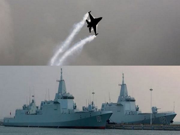 arafed jet flying over a ship and a navy ship