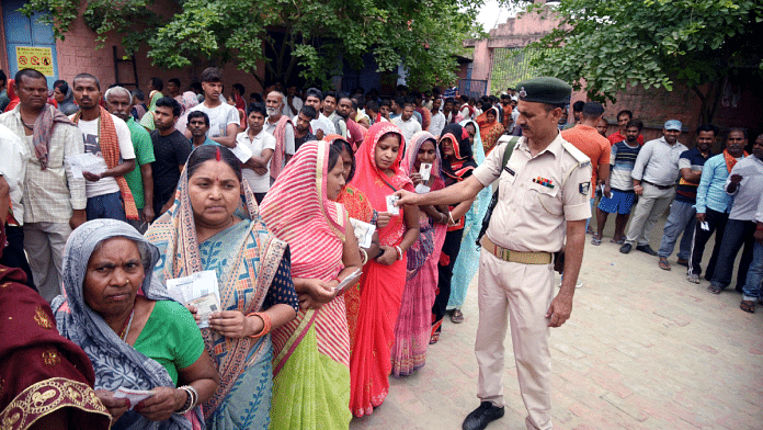 Representational image of voters waiting in queues to cast their vote at a polling station for the third phase of LS polls, in Khagaria on 7 May | Credit: ANI