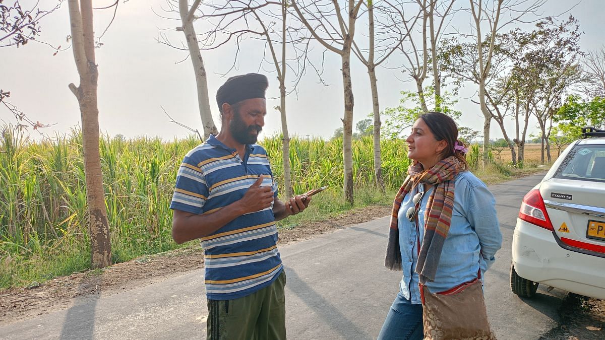 A villager in conversation with producer of Hanere Di Panchi, Reema Kaur | Tina Das, ThePrint