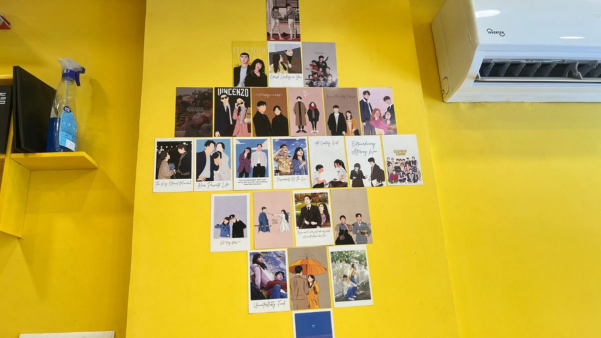 The wall full of postcard-sized illustrations of K-drama photos | Photo: Monami Gogoi