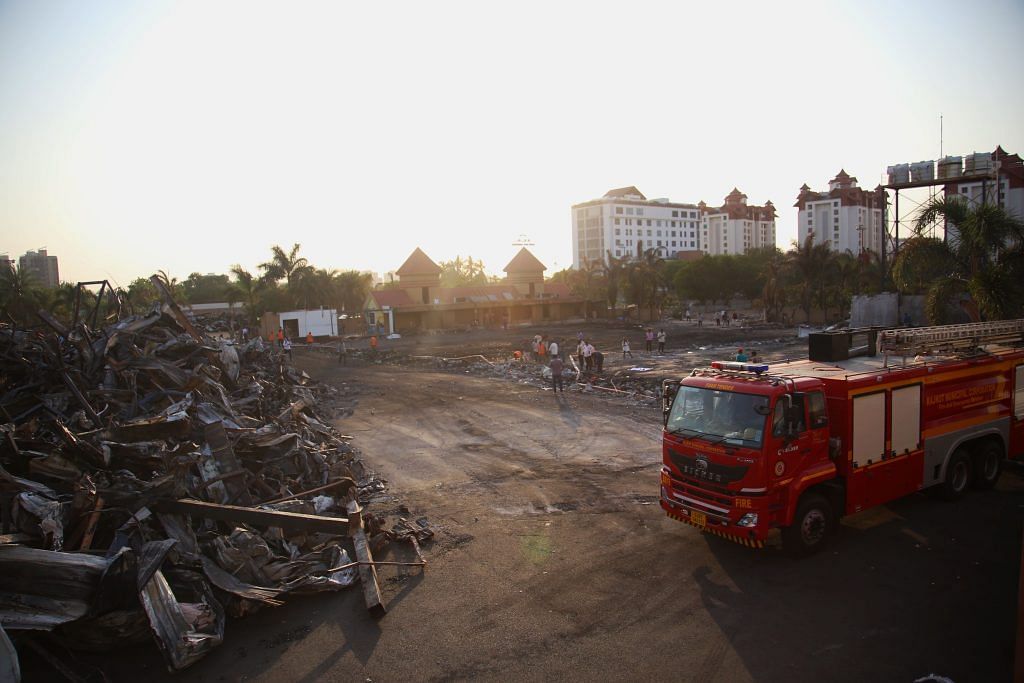 A fire truck and a pile of debris at the site of TRP Gaming Zone in Rajkot | Manisha Mondal | ThePrint