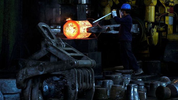 An employee moves forging red hot steel inside the ArcVac ForgeCast factory, in Hooghly district, in the eastern state of West Bengal, India, April 26, 2024. REUTERS/Sahiba Chawdhary/File Photo
