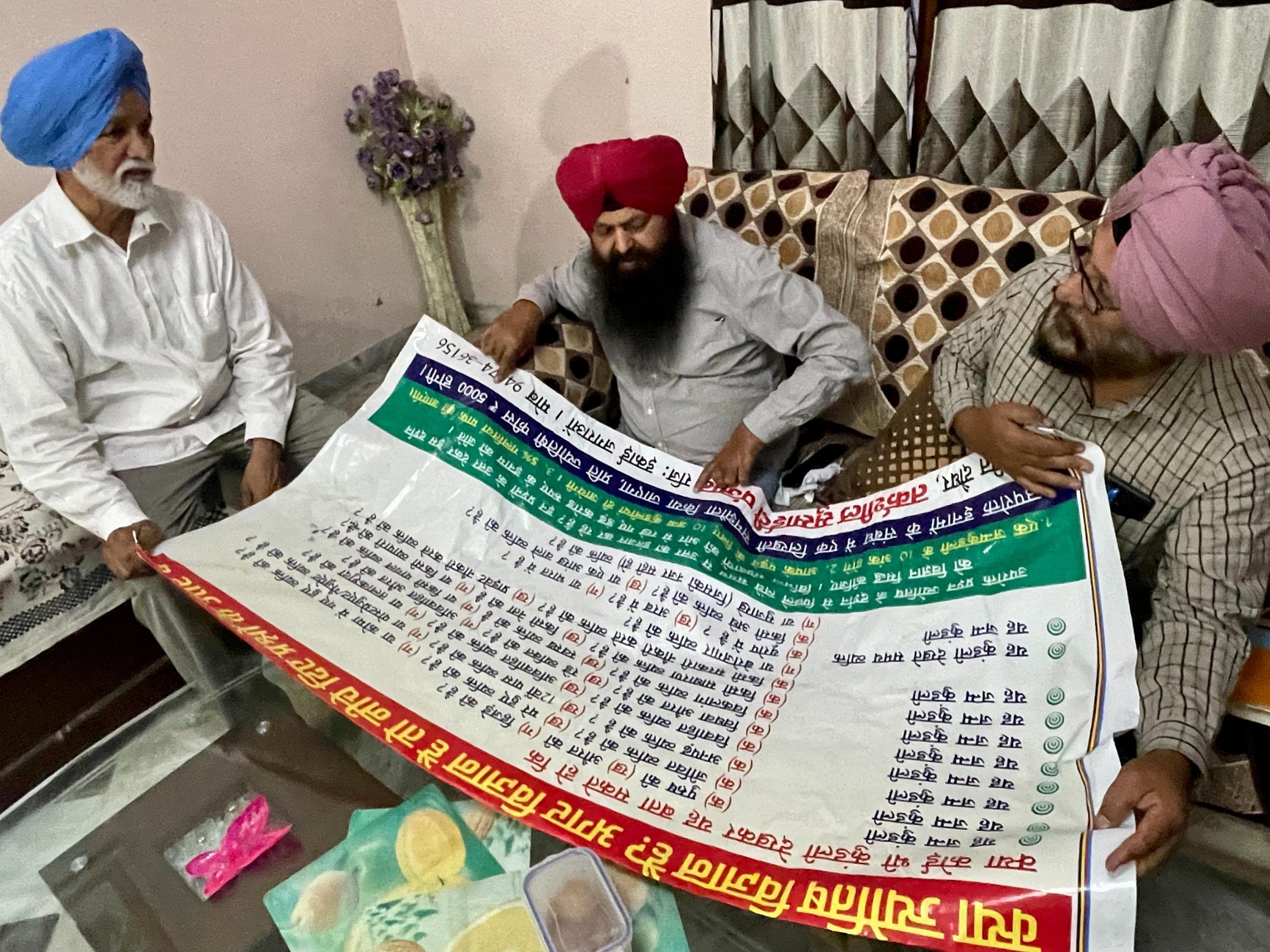 Rationalists in Barnala examine a large flex-banner asking whether 'jyotish' or astrologers can be considered scientists | Sabah Gurmat, ThePrint