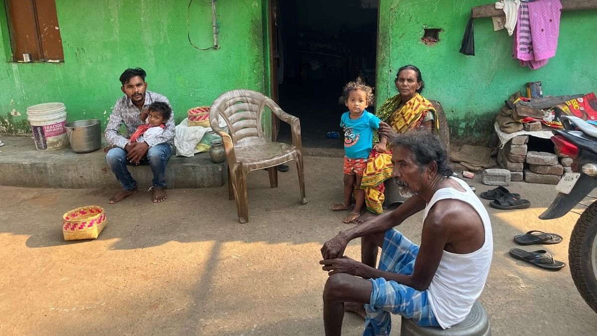 Pratap Bibhar and his family outside their pucca house in Bhatangpadar | Moushumi Das Gupta | ThePrint