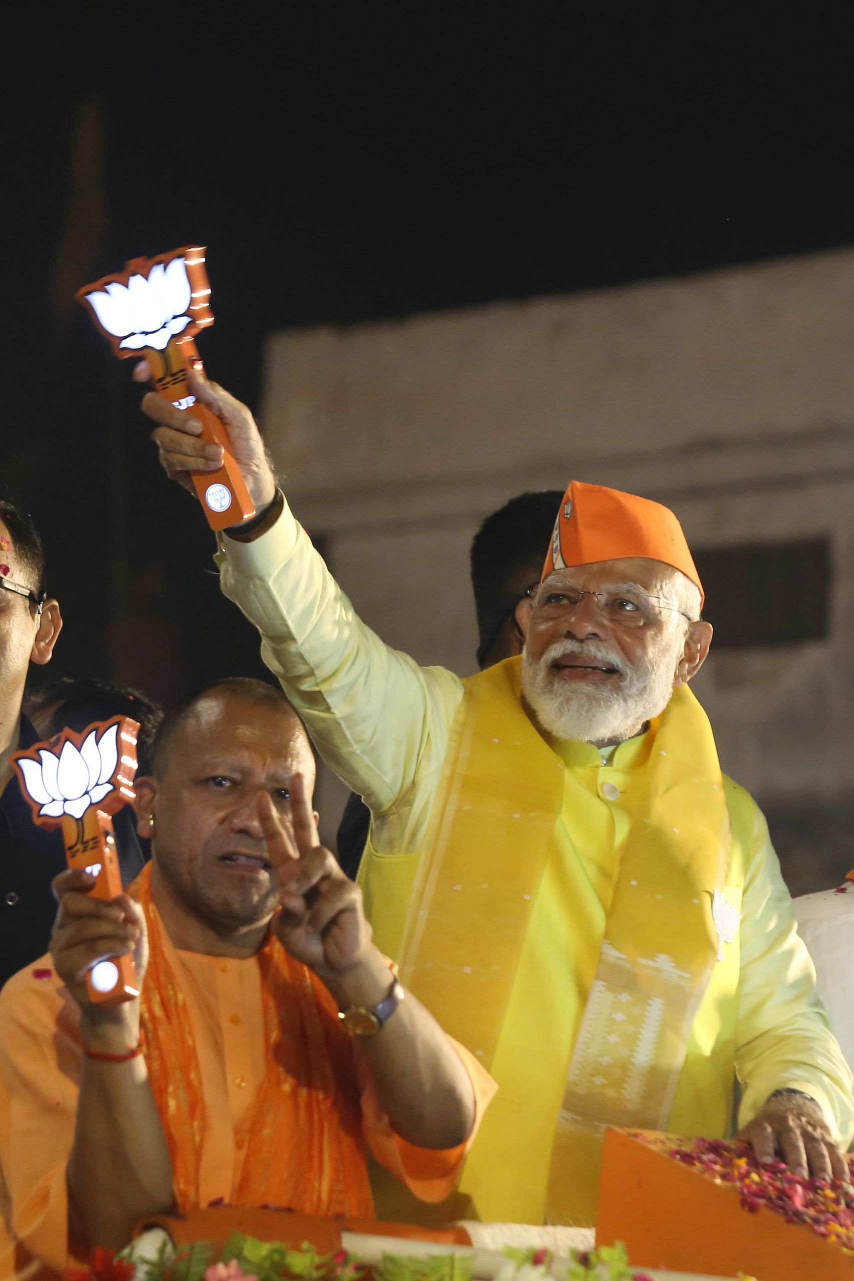 Prime Minister Modi, accompanied by CM Adityanath, holding a BJP-themed lamp | Suraj Singh Bisht | ThePrint