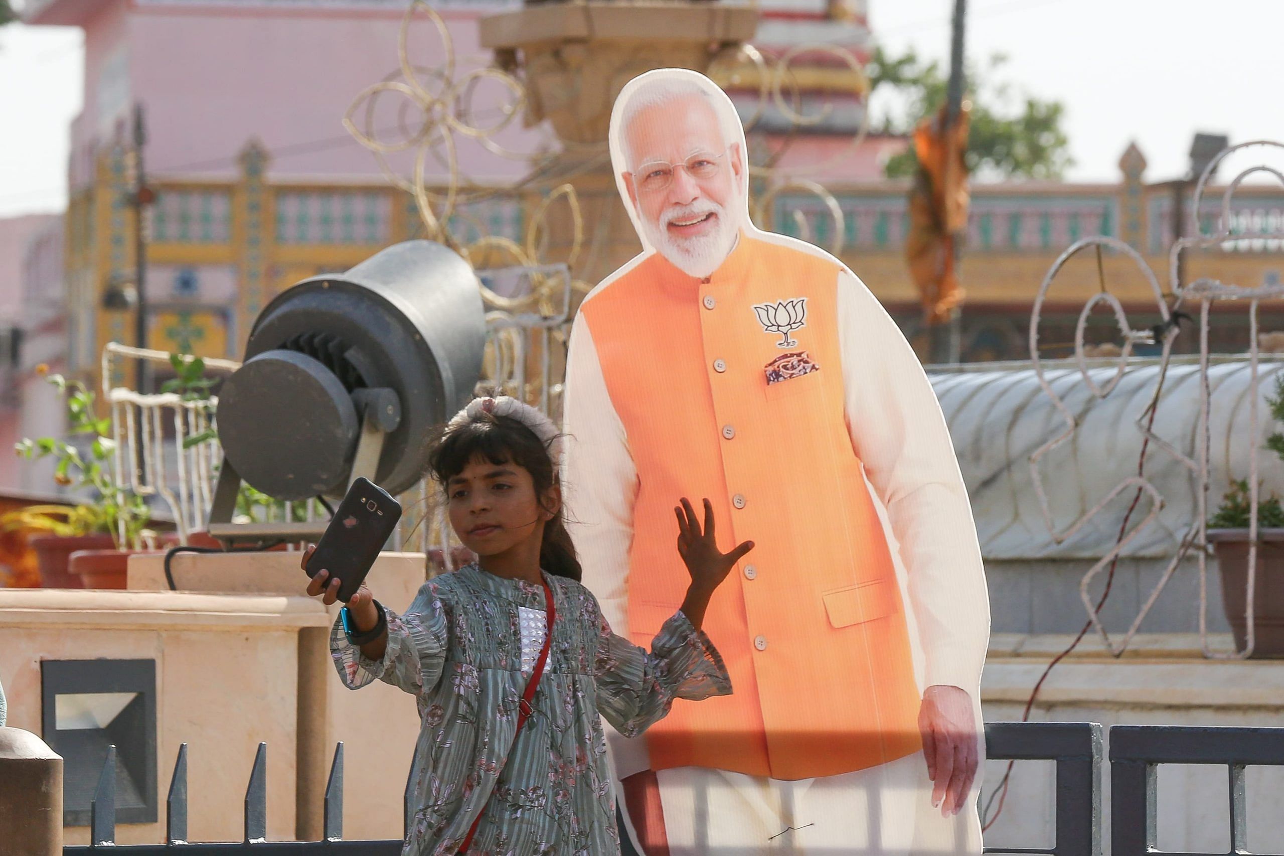 A young girl capturing a selfie with a hoarding of PM Modi | Suraj Singh Bisht | ThePrint