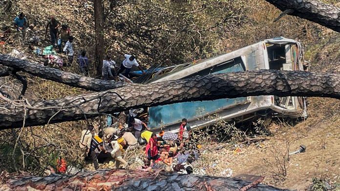 Police personnel and civilians near the wreckage of the bus which skidded off the road and fell into a gorge at Chowki Choura, in Jammu district, Thursday | PTI