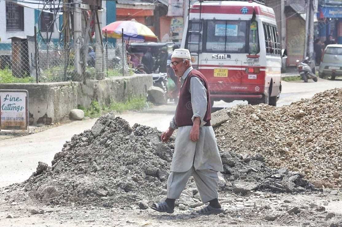A man walks across a battered road in Srinagar | Praveen Jain | ThePrint