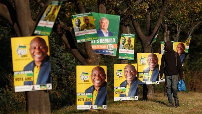 A man walks past election posters of the ruling African National Congress (ANC), as South Africa prepares for the May 29 general elections, in Soweto, South Africa, May 24, 2024. REUTERS/Siphiwe Sibeko