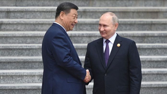 Russian President Vladimir Putin and Chinese President Xi Jinping attend an official welcoming ceremony in Beijing | Sputnik/ Sergei Bobylev | Reuters