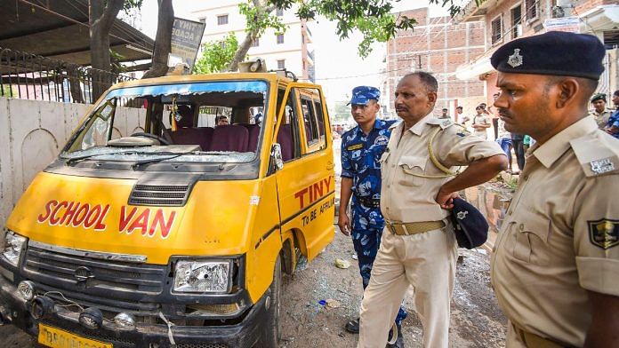 Police personnel inspect a vehicle vandalised after a child was allegedly found dead inside school premises in Patna | PTI