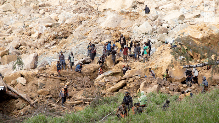 People clear an area at the site of a landslide in Yambali village, Enga Province, Papua New Guinea, May 27, 2024. UNDP Papua New Guinea | Handout via Reuters
