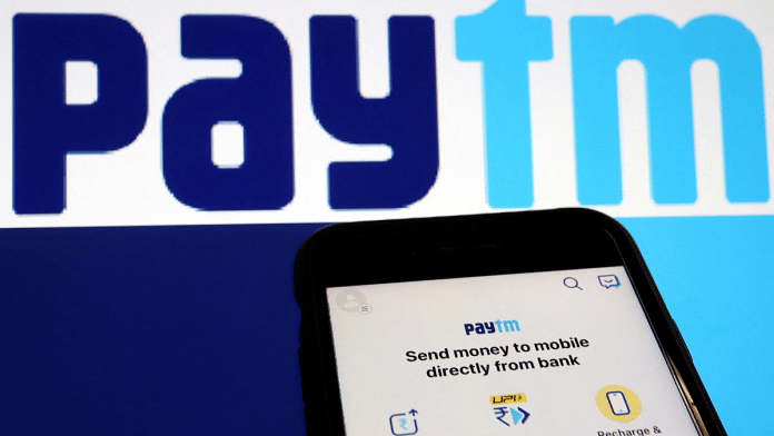 The interface of Indian payments app Paytm is seen in front of its logo displayed in this illustration | Reuters | Florence Lo | File Photo