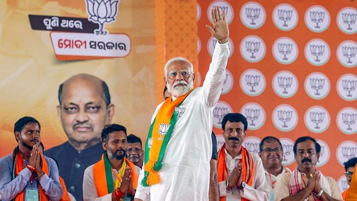 Prime Minister Narendra Modi greets supporters during a public meeting ahead of the seventh phase of Lok Sabha elections, in Kendrapara district, Wednesday, May 29, 2024. (PTI Photo)