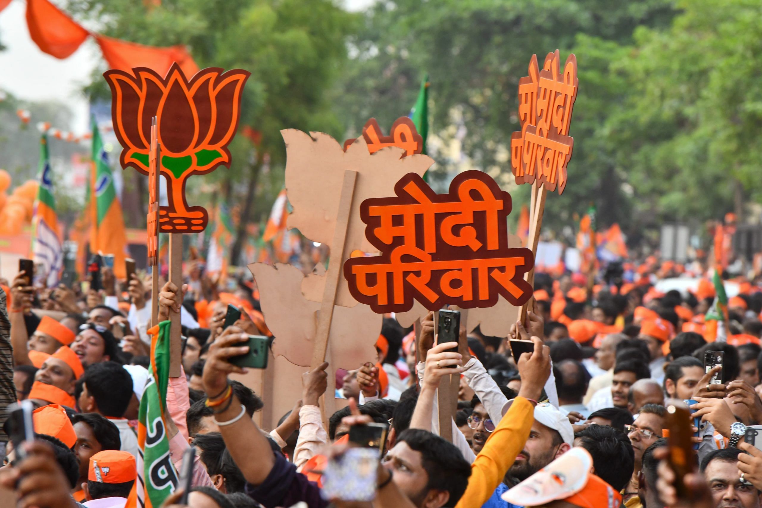 A supporter with ‘Modi parivar' poster during the roadshow | Suraj Singh Bisht | ThePrint