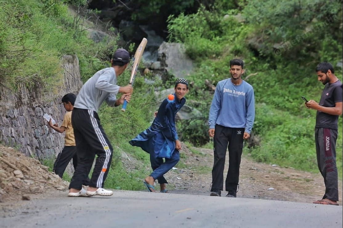 Children playing cricket on an empty road in Sultan Dhaki in Uri | Praveen Jain | ThePrint