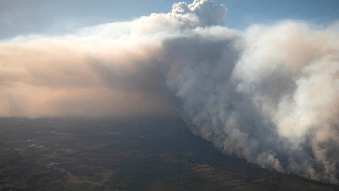 Representational image of of Chuckegg Creek wildfire burns out of control in High Level Forest Area, near the town of High Level, Alberta, Canada on 21 May, 2019 | Credit: Reuters