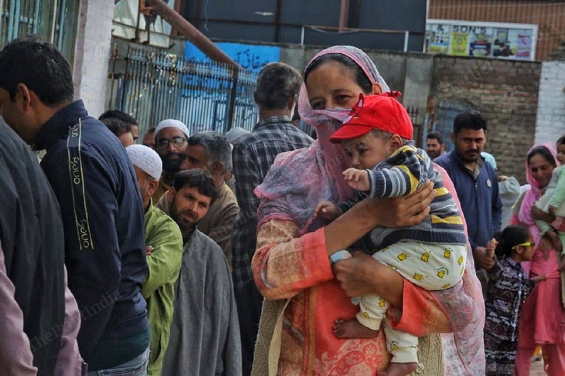 A woman voter with her child at a polling booth | Praveen Jain | ThePrint