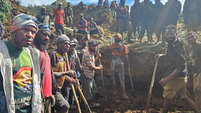Locals gather amid the damage after a landslide in Maip Mulitaka, Enga province, Papua New Guinea 24 May, 2024 in this obtained image. Emmanuel Eralia via Reuters