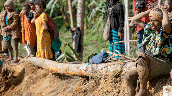 Onlookers react as people clear an area at the site of a landslide in Yambali village, Enga Province, Papua New Guinea, 27 May 2024 | UNDP Papua New Guinea/Handout via Reuters