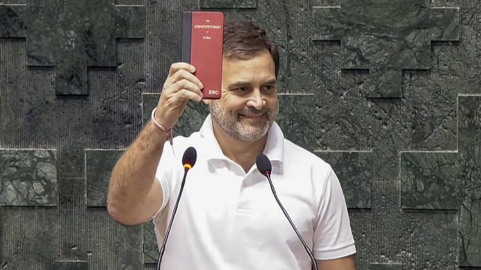 Congress MP Rahul Gandhi shows a copy of the Constitution of India while taking oath as a Member of the 18th Lok Sabha during its second day, at the Parliament, in New Delhi | ANI Photo/SansadTV