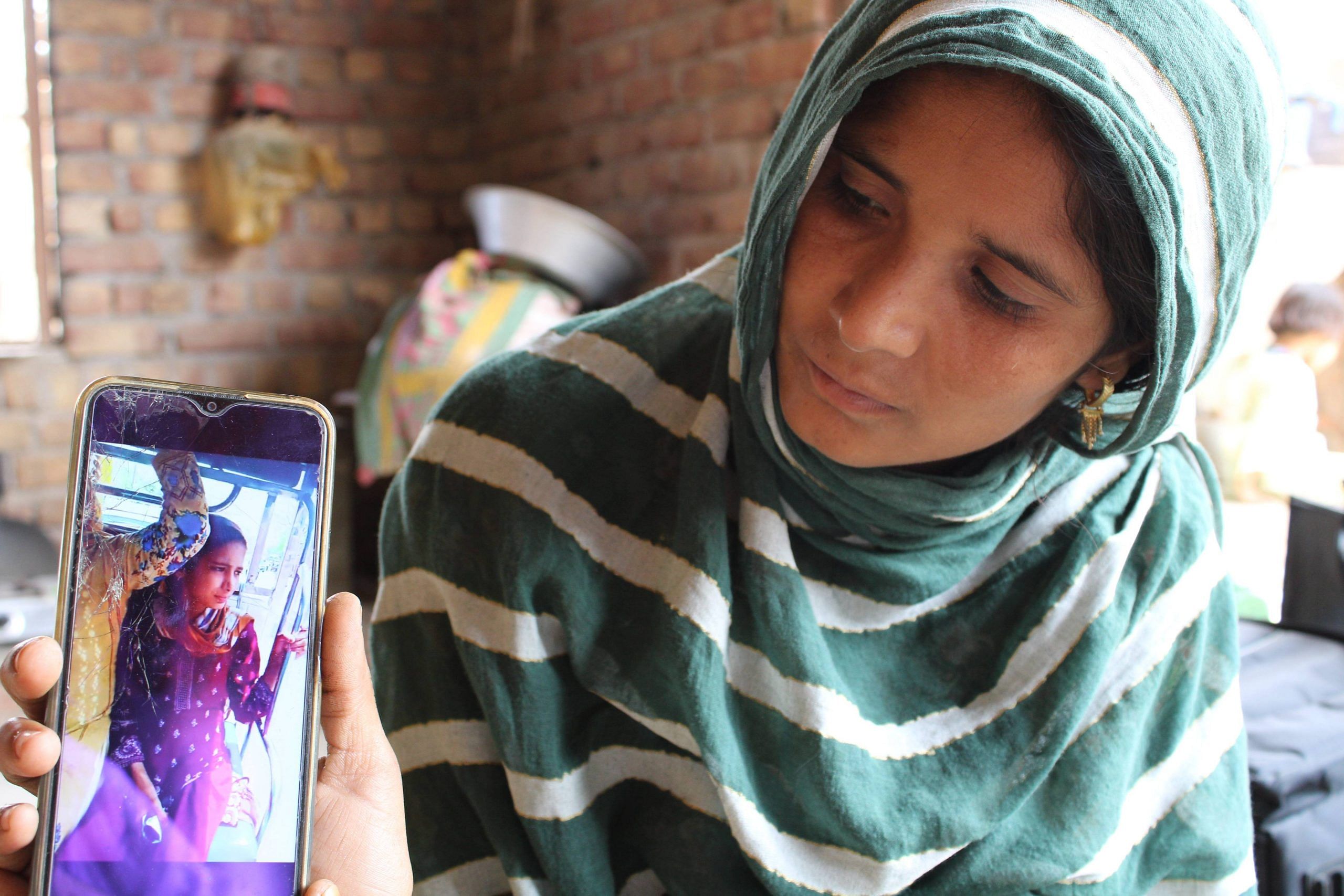 Sajida shows a picture of her elder daughter, Parwana, during a hospital visit. Junaid's death shook his 14-year-old daughter to the core, ultimately leading to her death. Photo | Heena Fatima | ThePrint