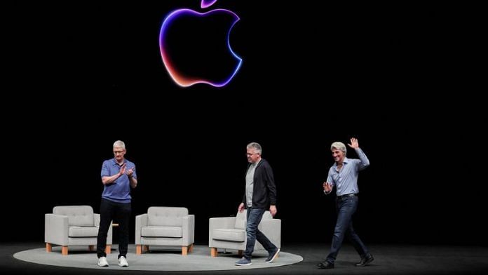Apple CEO Tim Cook attends a panel discussion with Craig Federighi and John Giannandrea during the annual developer conference event at the company's headquarters in Cupertino, California, U.S., June 10, 2024. REUTERS/Carlos Barria
