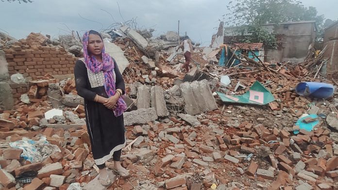 Asiya Bi standing next to debris of her demolished house | Iram Siddique | ThePrint