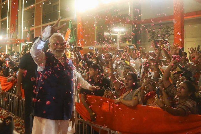 Prime Minister Narendra Modi greets party workers upon his arrival for a meeting at the party headquarters as the party leads in the Lok Sabha elections amid the counting of votes, in New Delhi | Suraj Singh Bisht | ThePrint