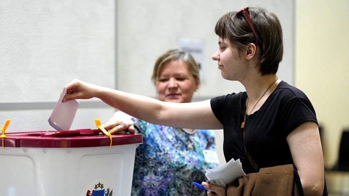 A woman casts her vote during the European Parliament election, in Riga, Latvia June 8, 2024 | Reuters