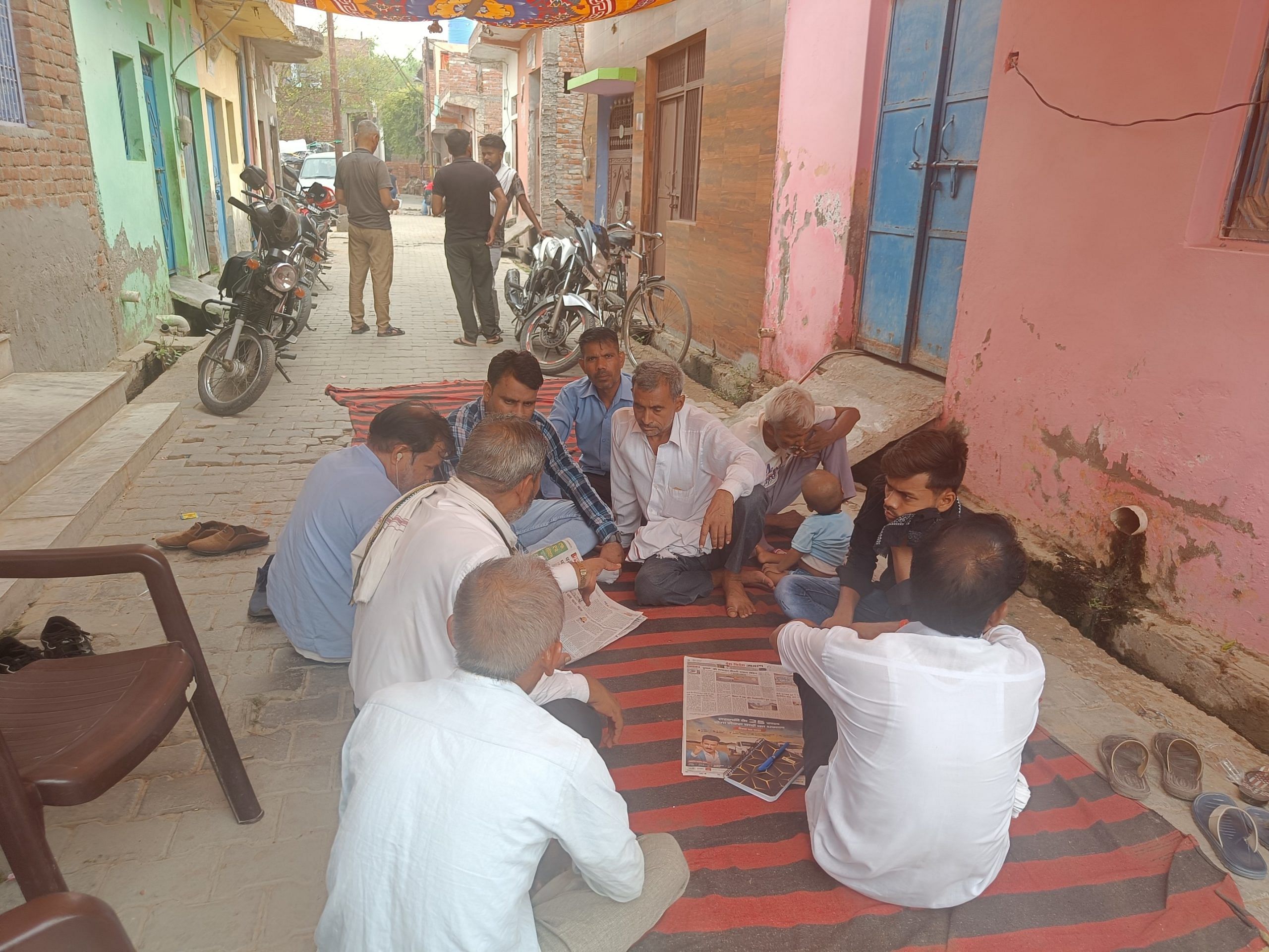 Relatives and neighbours of Akash Singh sitting outside his house | Photo: Krishan Murari/ThePrint