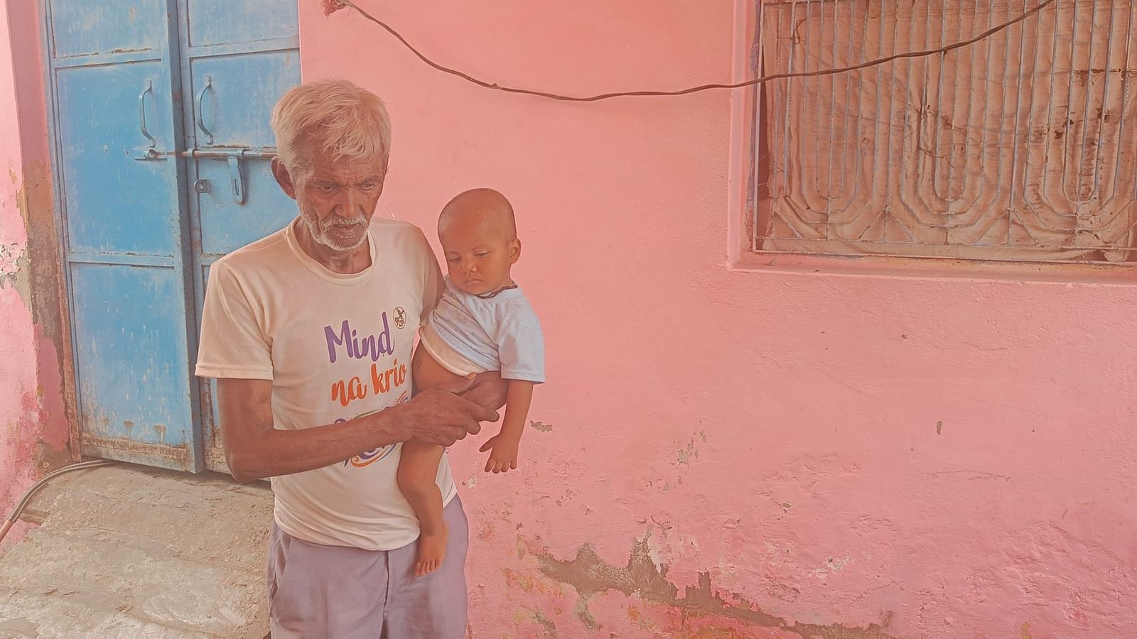 Akash Singh's father Biri Singh holding his 1.5 year old granddaughter | Photo: Krishan Murari/ThePrint